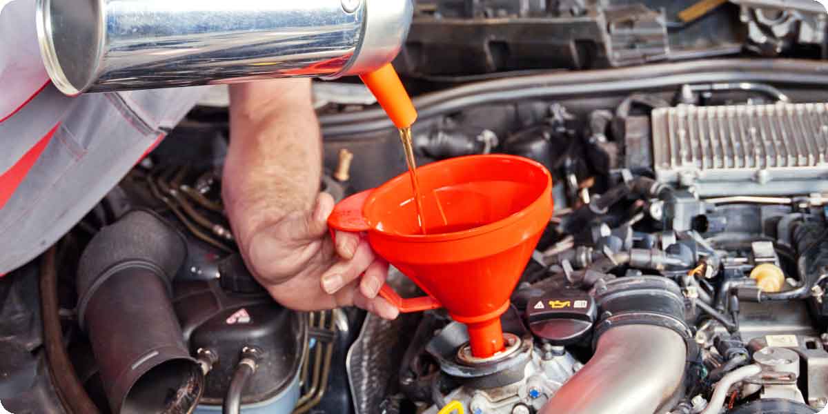 Motoröl wird mit einem Trichter nachgefüllt.